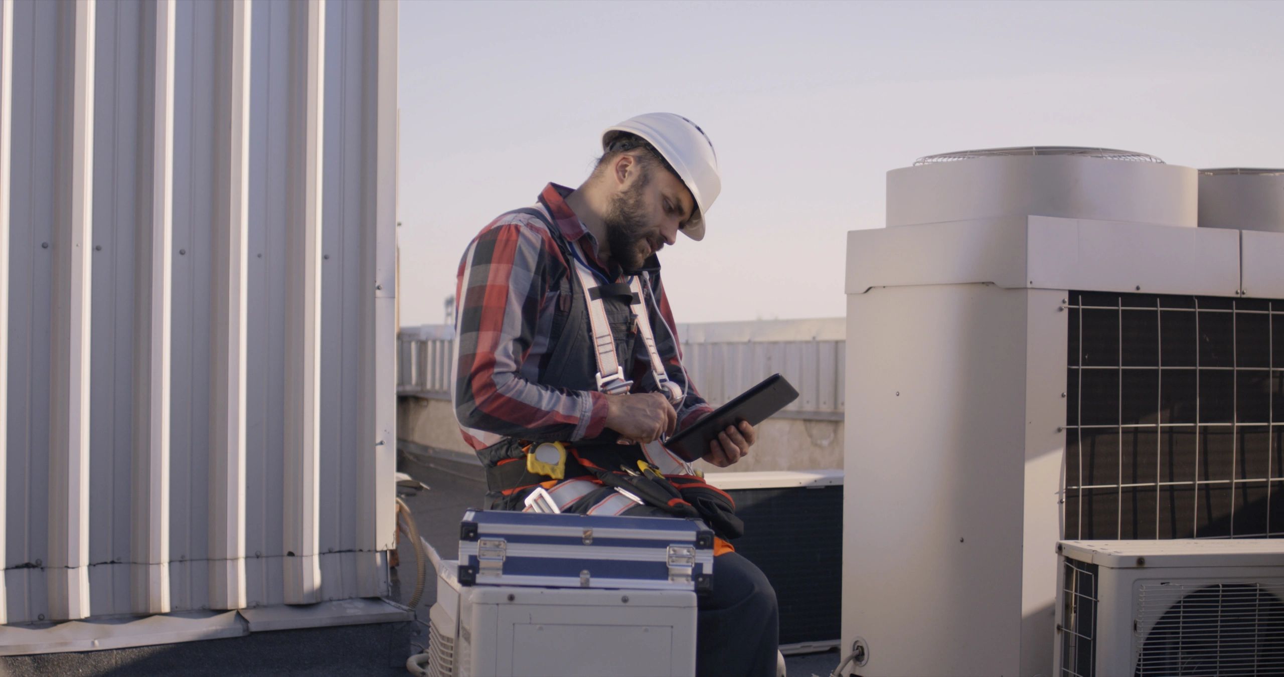 HVAC engineer inspecting system performance with a tablet