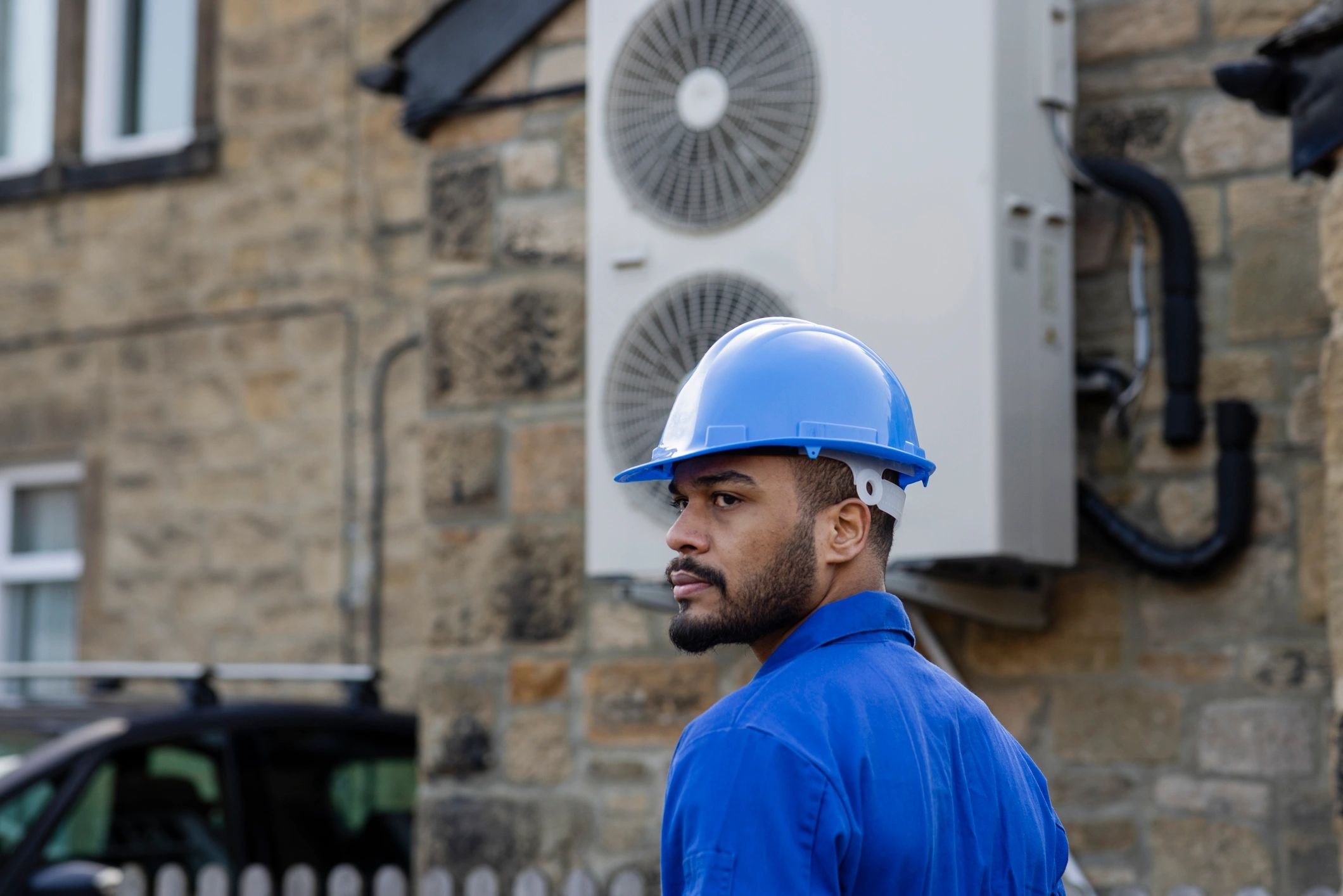 Technician installing a residential cooling system