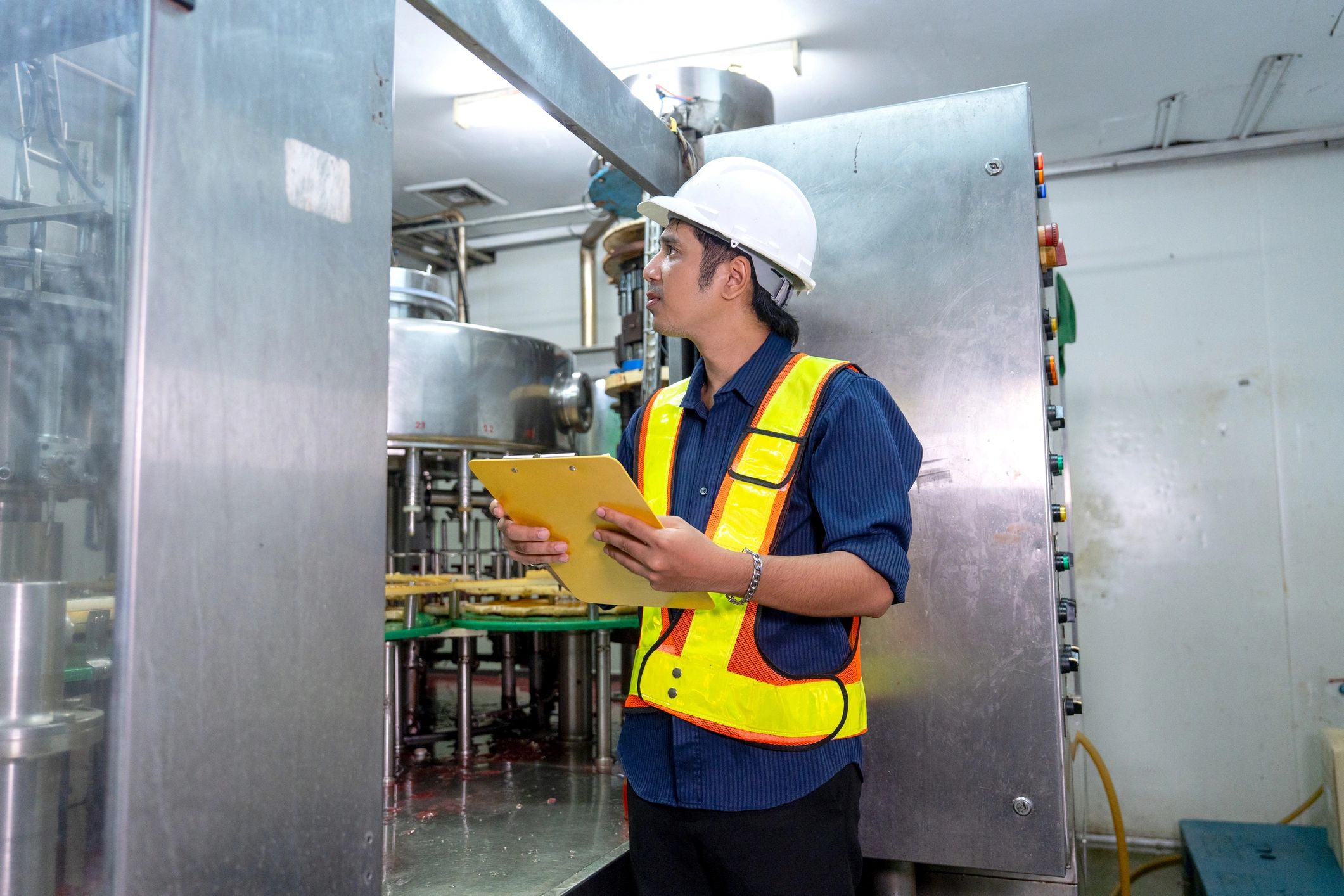 HVAC technician inspecting equipment in a commercial setting