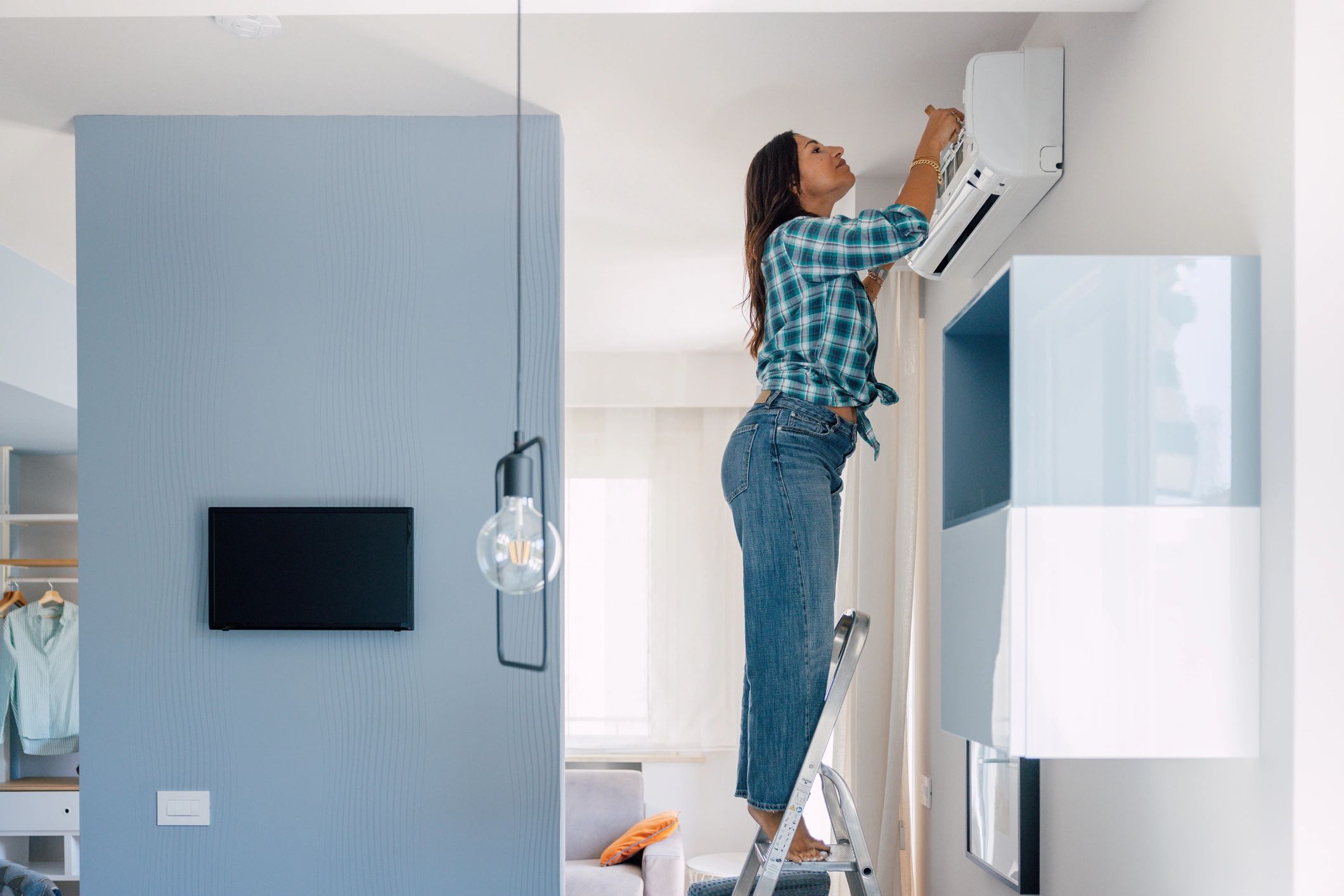 Technician servicing an indoor air conditioner unit